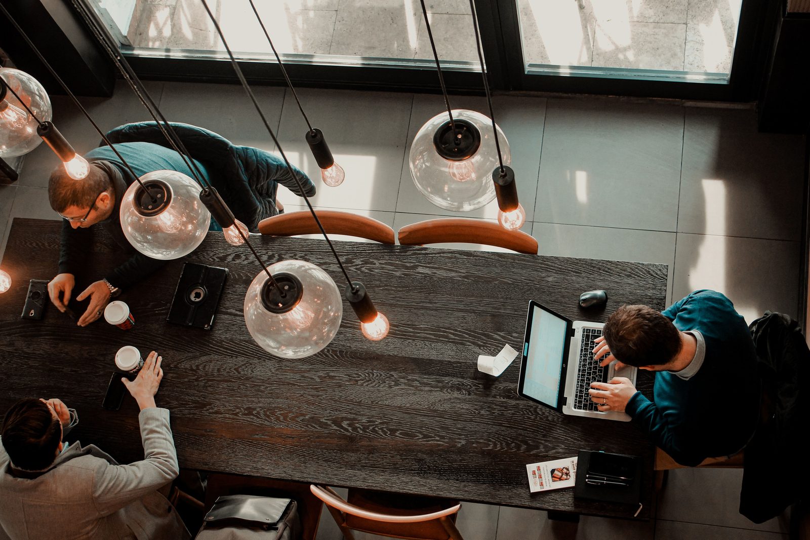 A team reviewing plans and data together around a table — the business case behind the growing wellness economy.
