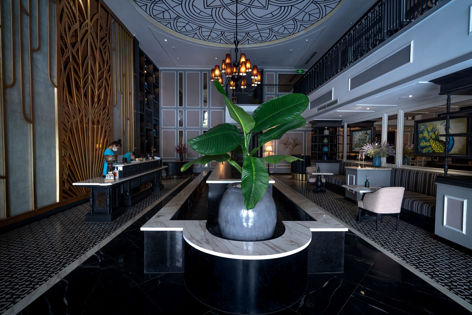 A premium hotel lobby with art-deco details and a striking indoor plant, representing existing wellness and hospitality facilities.